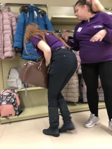 Nice candid shop assistant wearing tight pants bending over