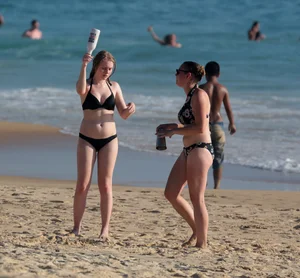 Cute bikini girl in the water in a black bikini