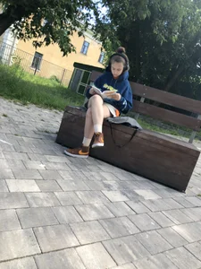Cute candid teens reading on street benches