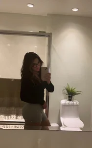Candid girl wearing glasses and spandex shorts mirror selfie