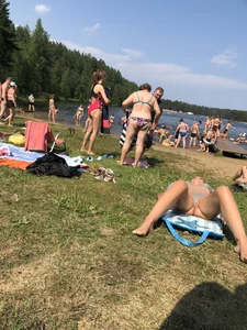 Milf in a Swimsuit Lying With Spread Legs on a Beach