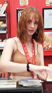 Redhead cutie in a top store photo