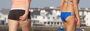 Beach babe in a blue bikini with thick friend in shorts