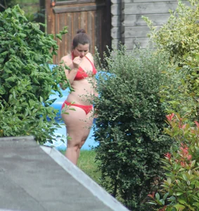 Thick babe in the backyard in red bikini