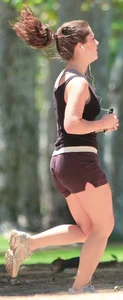 Cute girl running in short shorts