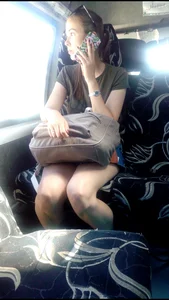 Girl in a Skirt Speaking in the Phone in a Bus