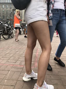 Hot Candid Girl in a Top, Shorts and Sneakers Skinny Legs Closeup Creepshots Gallery on the City Street