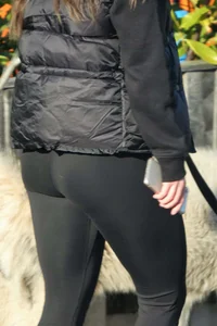 Pouting brunette teen in black leggings