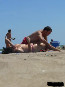Purple thong topless lady on the beach gets oiled up by her husband