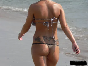 Tattooed blonde with big tits topless and in thong