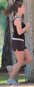 Cute girl running in short shorts