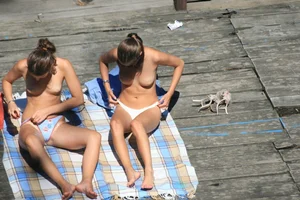 Two teens stripping and going topless to tan
