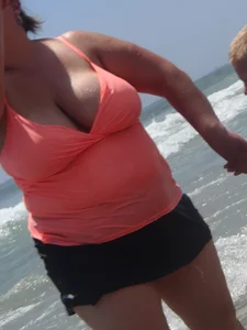 Thick lady on the beach with huge tits