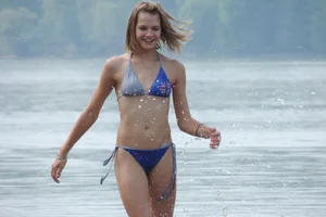 Skinny teen having fun in her little England bikini