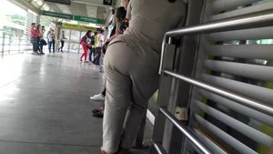Big booty Latina lady in tight pants standing around