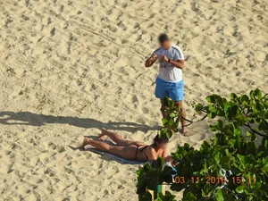 Big booty beach babe laying out in thong
