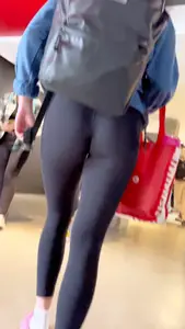 College girl going up the stairs with leggings and pink crocs