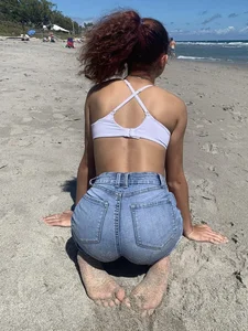 Hot girl in denim shorts at the beach photos