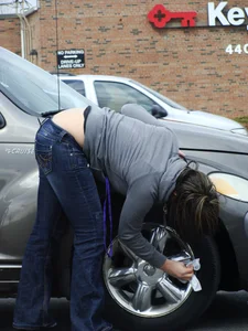 Girl cleaning her car in jeans and showing some cheetah print underwear