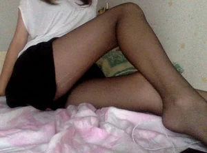 Girl Sitting in Bed in a Skirt - Nice Torn Pantyhose and Feet