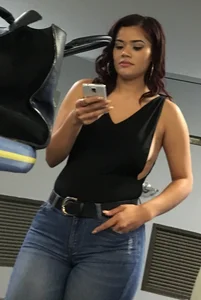 Thick brunette in tight jeans and showing some side boob