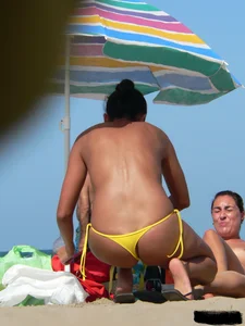 Bunch of sexy babes on the beach topless and in thong bikinis