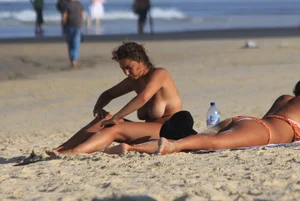 Sexy girls topless on a nude beach showing their nice tits