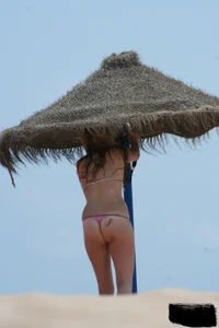 Hot beach girl undressing and going topless