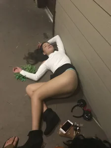 Girl in a Mini Skirt And Pantyhose Lying on the Street With Her Skirt Pulled Up