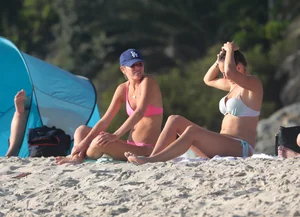 Two sexy friends out on the beach in bikinis