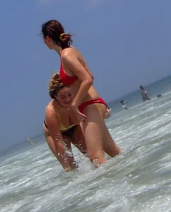 Thick girl and her skinny friend in bikinis at the beach