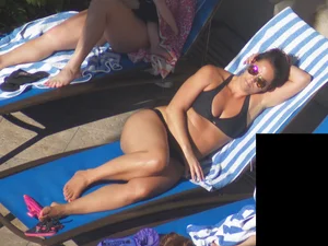 Milf laying out in black bikini by the pool