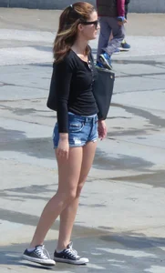 Cute girl with nice legs in short denim shorts