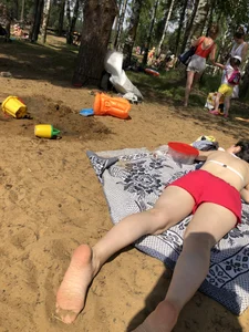 Pale Candid Girl in Shorts and a Bra Lying on the Beach Creepshots