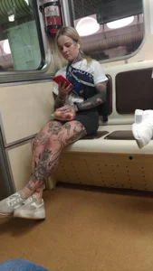 Girl Covered With Tattoos in the Subway Train Photo