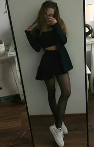 Hot skinny candid girl in a top, skirt and black pantyhose mirror selfie