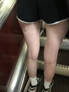 A Tall And Slim Candid Girl in Spandex Shorts in a Hoodie Top, With Tattoos on Her Long Legs Subway Creepshots