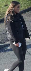 Pouting brunette teen in black leggings