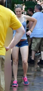 Cute blonde in denim shorts and a wet top