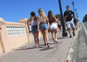 Three sexy friends in denim shorts and a skirt