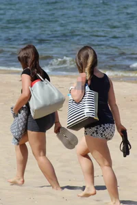 Thick and sexy friends out on the beach in shorts and bikinis