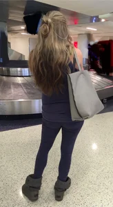 Pregnant blonde girl in leggings at the airport