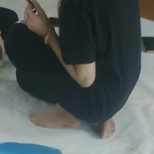 Skinny teen painting on the floor