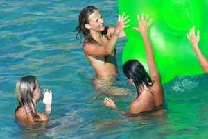 FKK Nudists playing in the water with floater