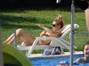 Topless lady at the pool with nice tits