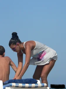 Hot ass topless beach girl with great tits lets her little brother oil up her ass in thong bikini