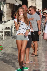 Sexy skinny blonde eating ice cream in short tight grey shorts