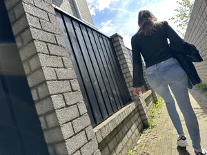 Sexy girl in tight blue jeans walking down a suburban street creepshots