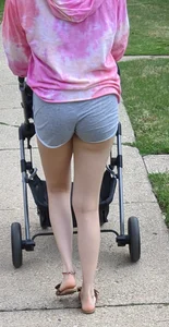 Milf with a nice ass in grey shorts pushing the stroller
