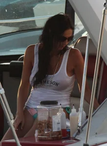 Bikini babe on a boat with a wet see through white shirt showing her tits